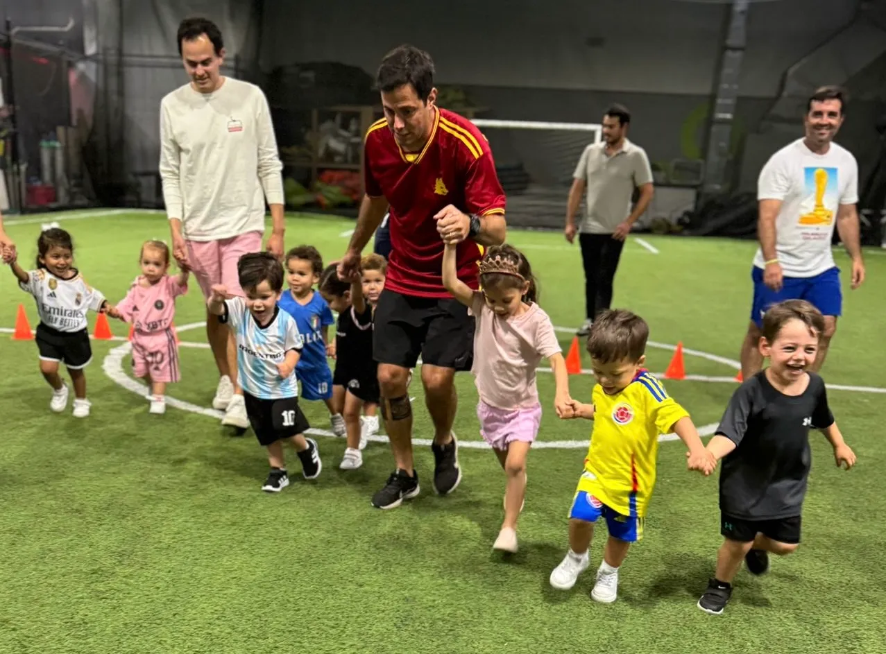 Toddler and parent playing with soccer ball at KidsPro Academy Miami